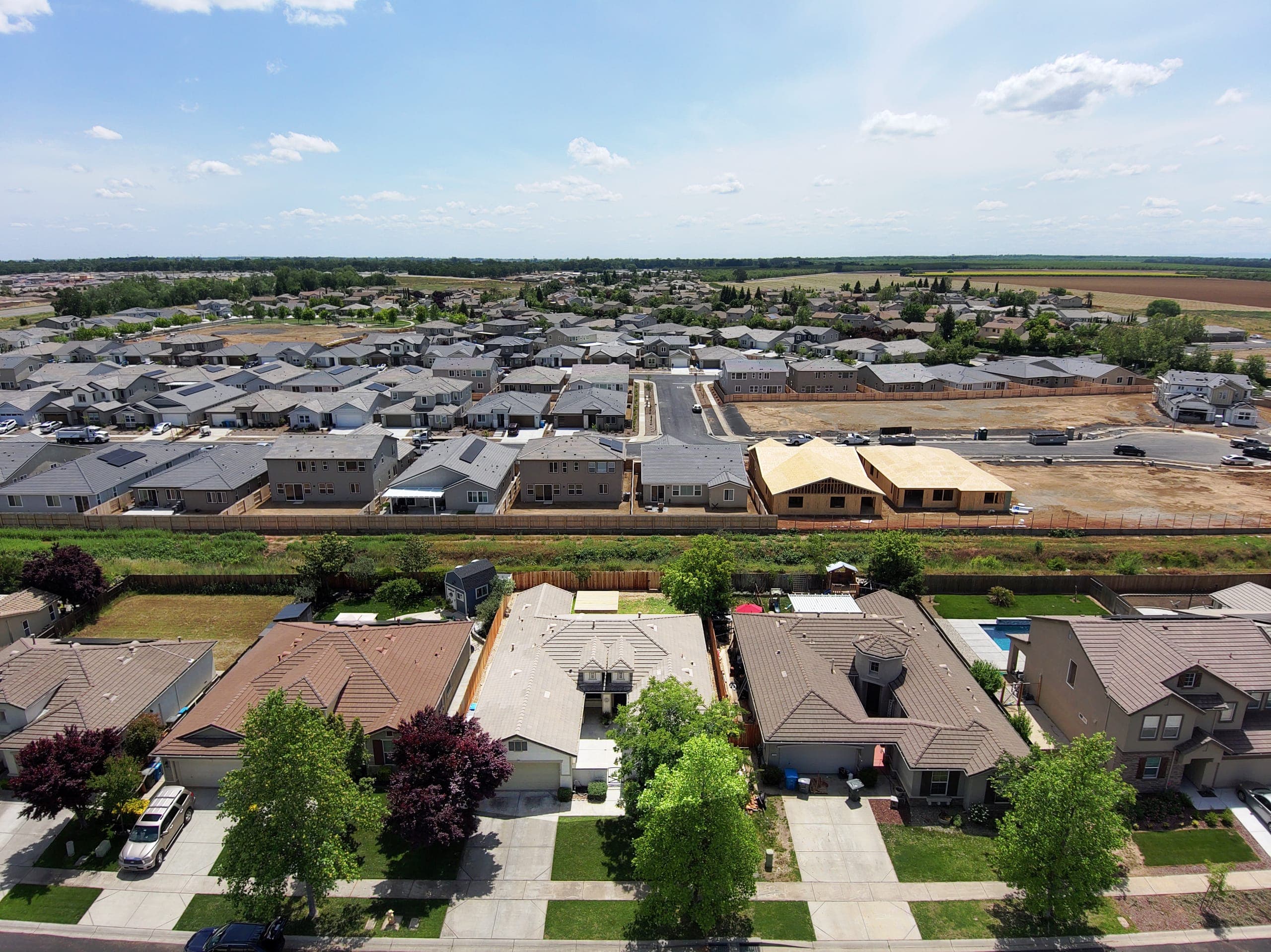 Aerial view of a newer suburban neighborhood with homes under construction